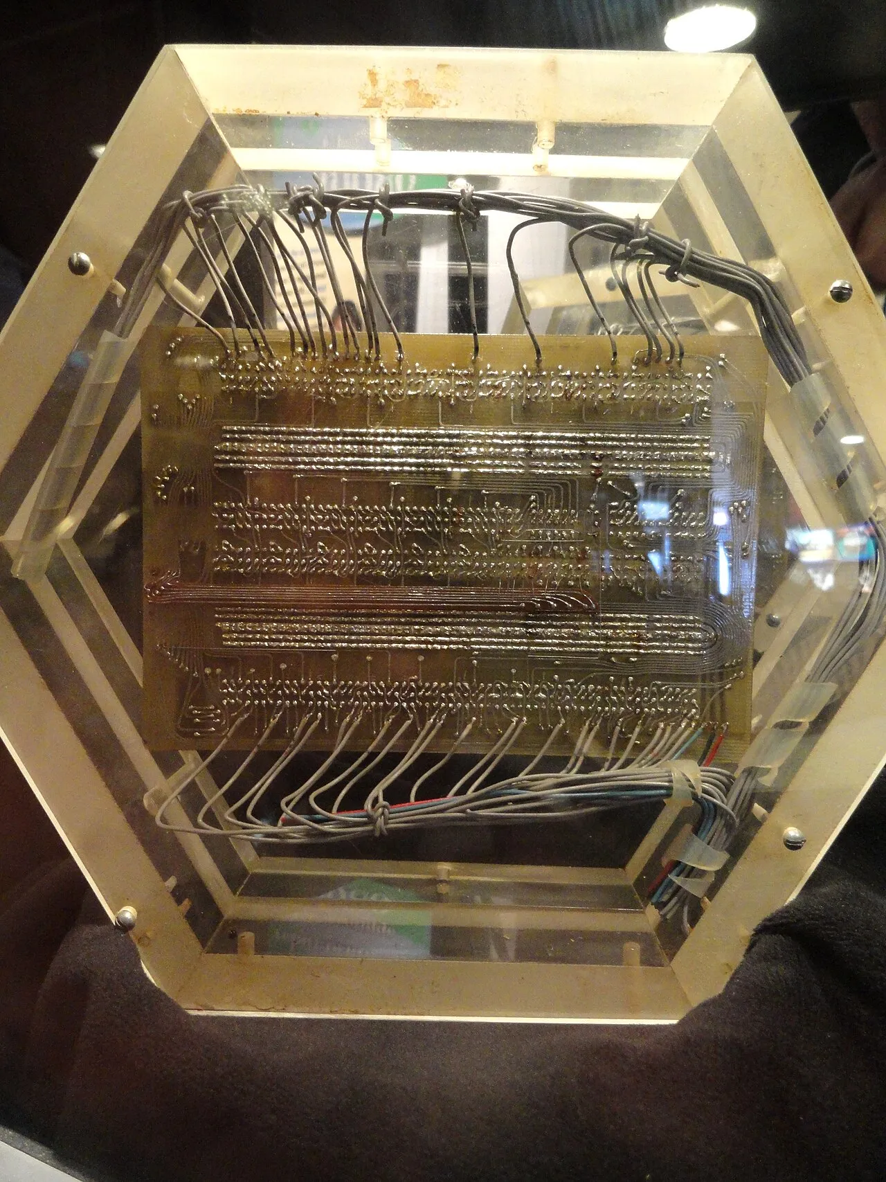 A hand-wired circuit board from ABNER, the NSA's first in-house digital computer, held in an acrylic frame
